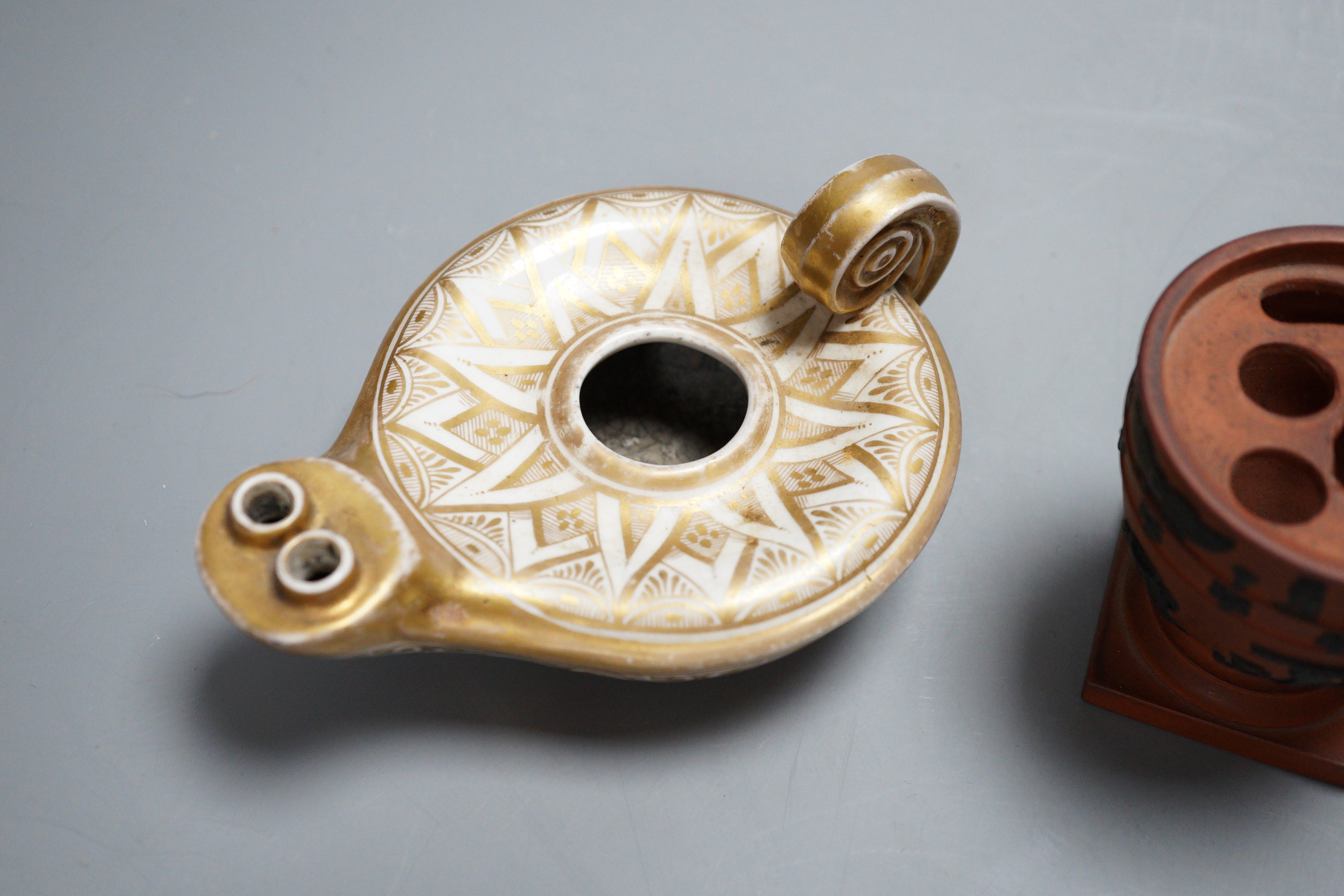 An 18th century English porcelain hot water jug, a Wedgwood two-colour terracotta pot and an early 19th century oil lamp, tallest 20cm